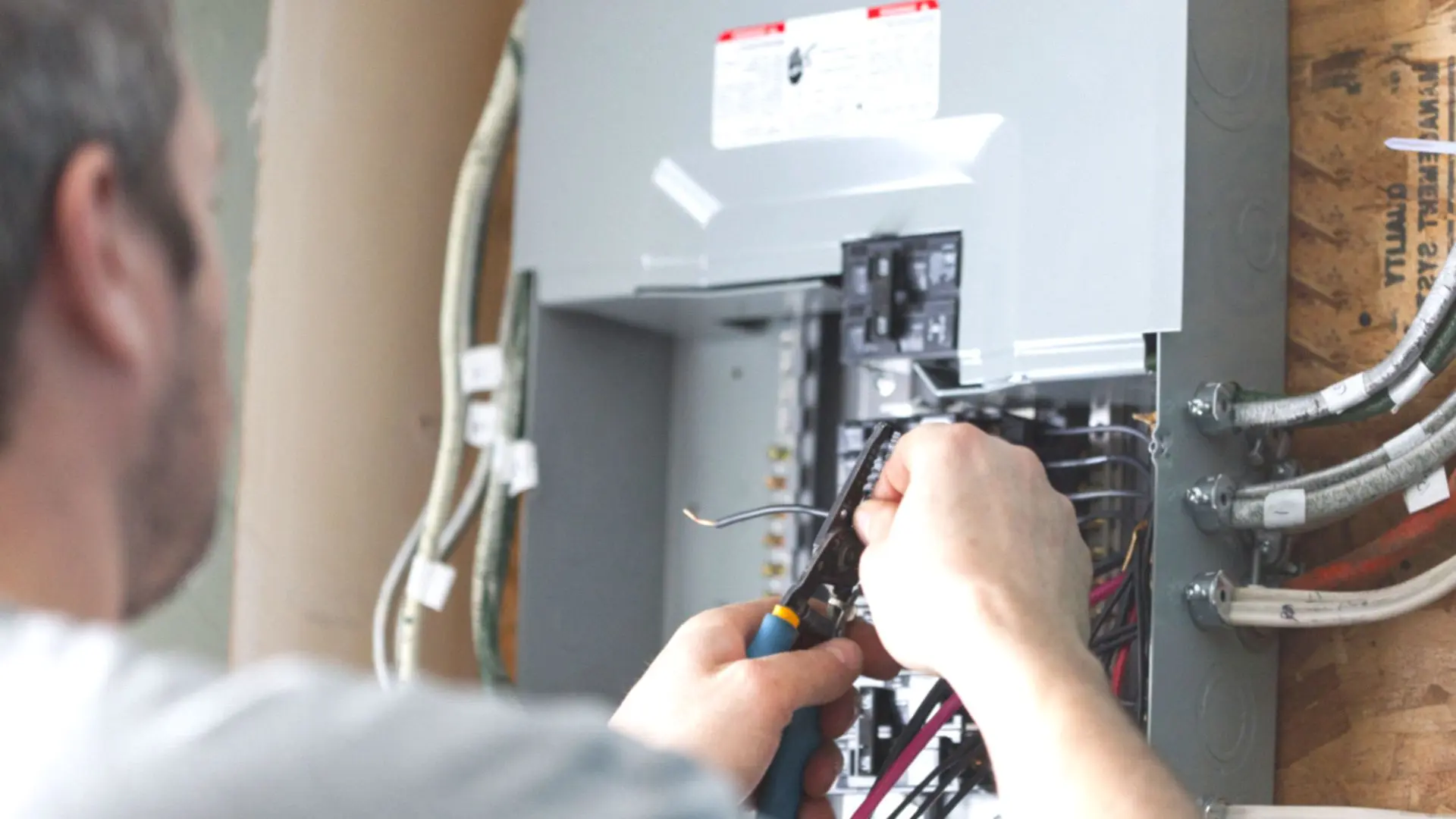 Man Checking Faulty Wires Switchboard