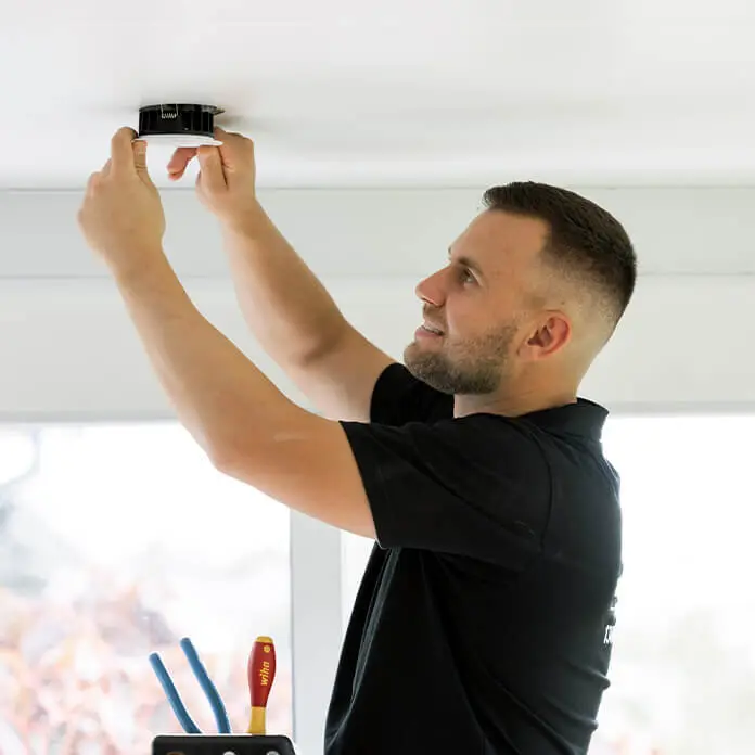 Daniel Vas Installing Light Fixture