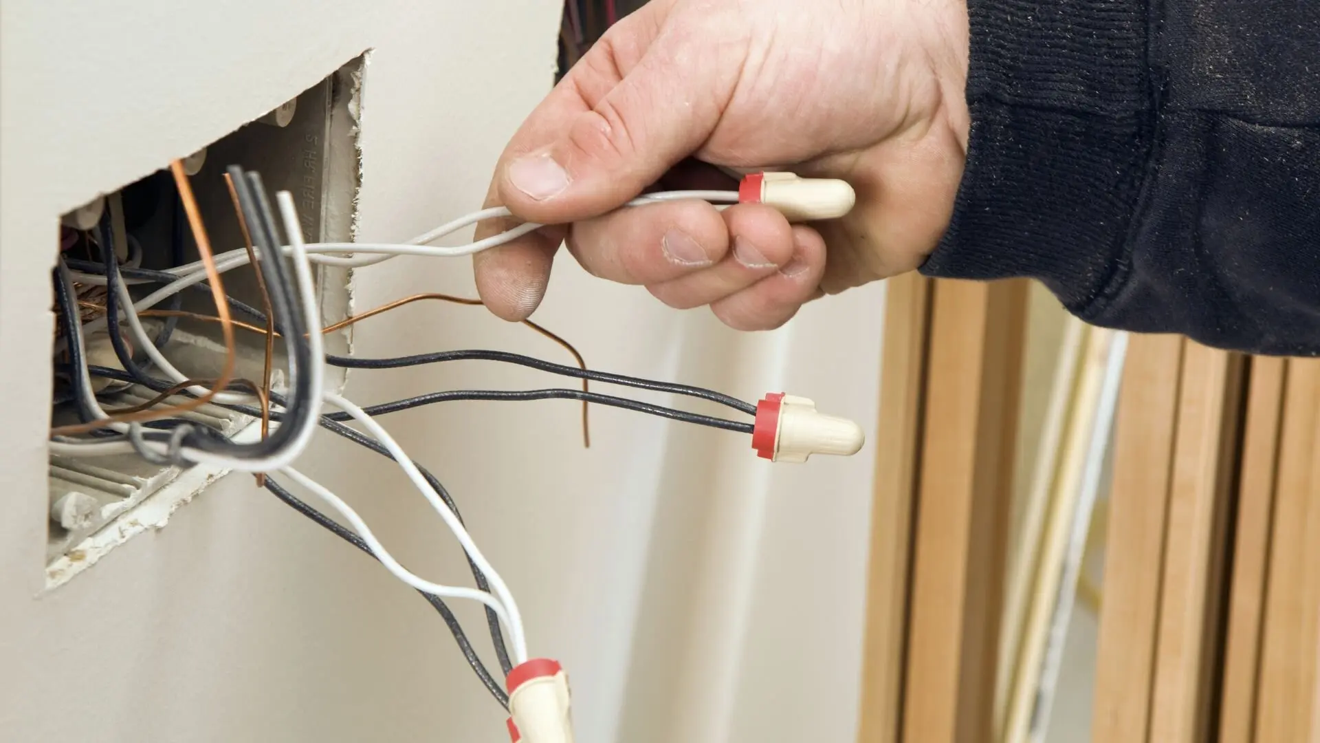 Electrician Pulling Small Wires Wall Socket