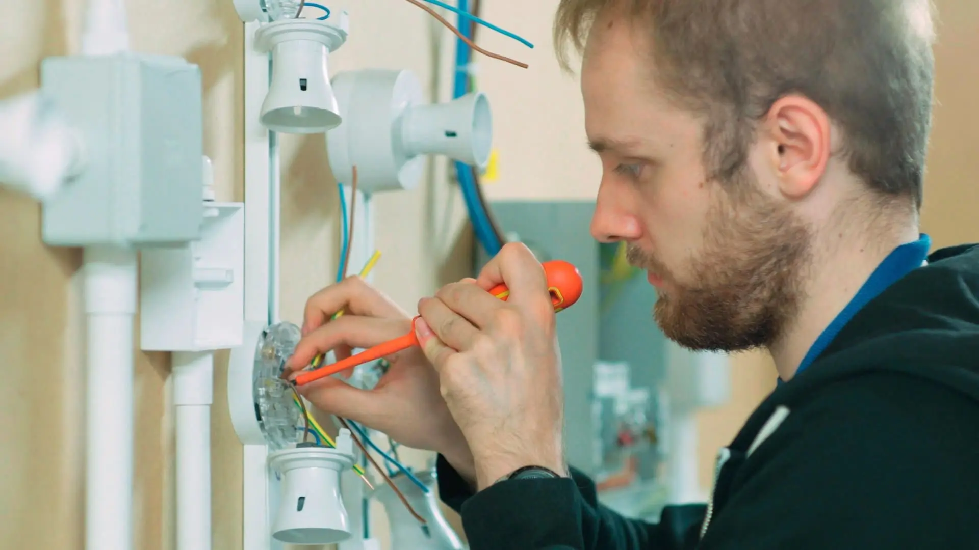 2023 10 Man Fixing Wires In Light Bulb Man Fixing Wires Light Bulb