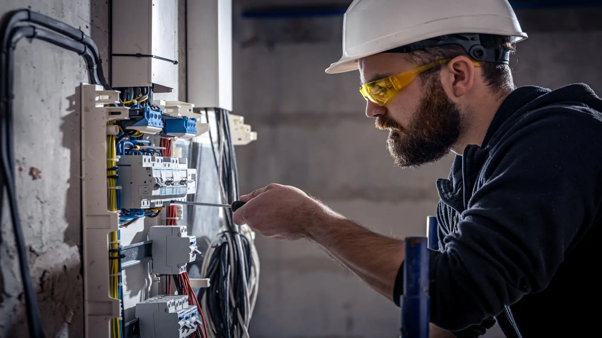 Male Electrician Works Switchboard Electrical Connecting Cable