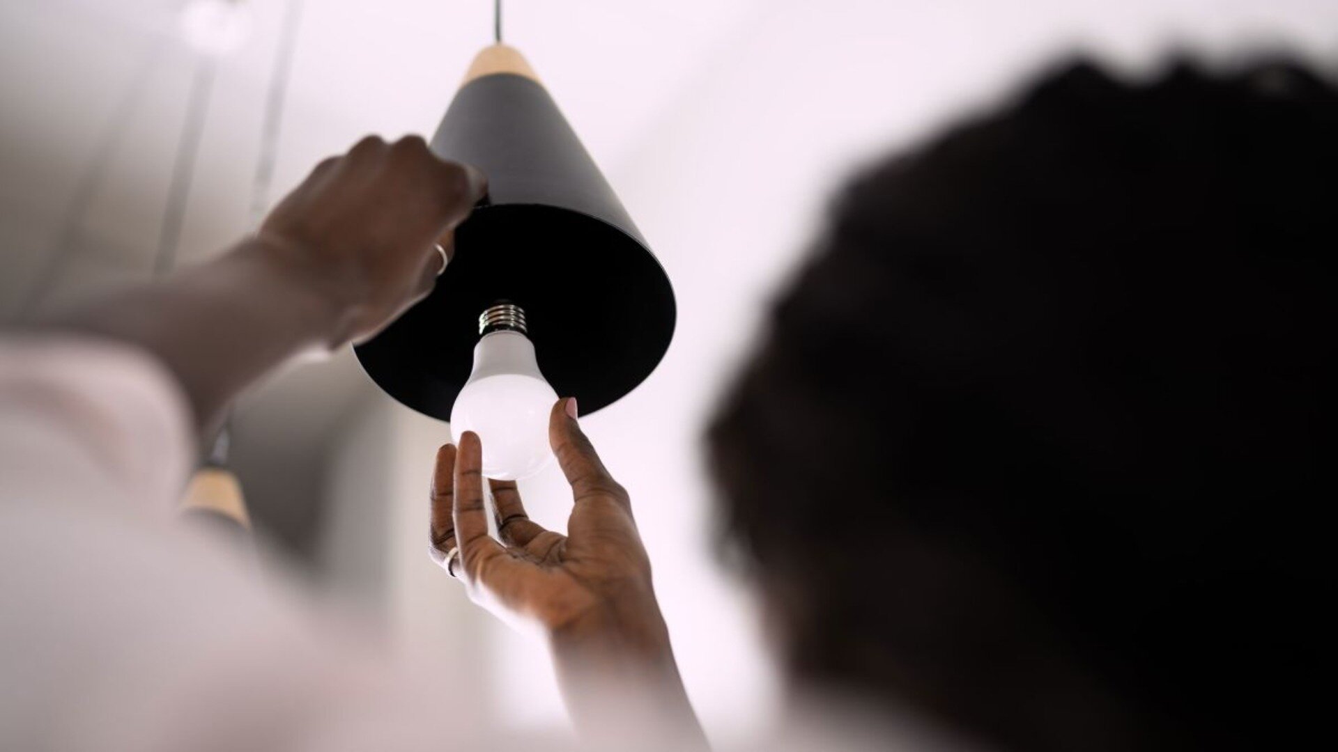 Woman Inserting Bulb