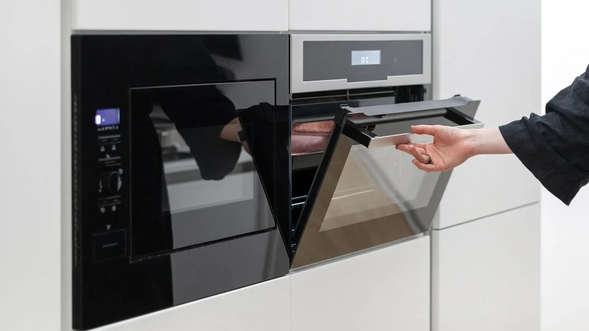 Person Opening Electric Wall Oven