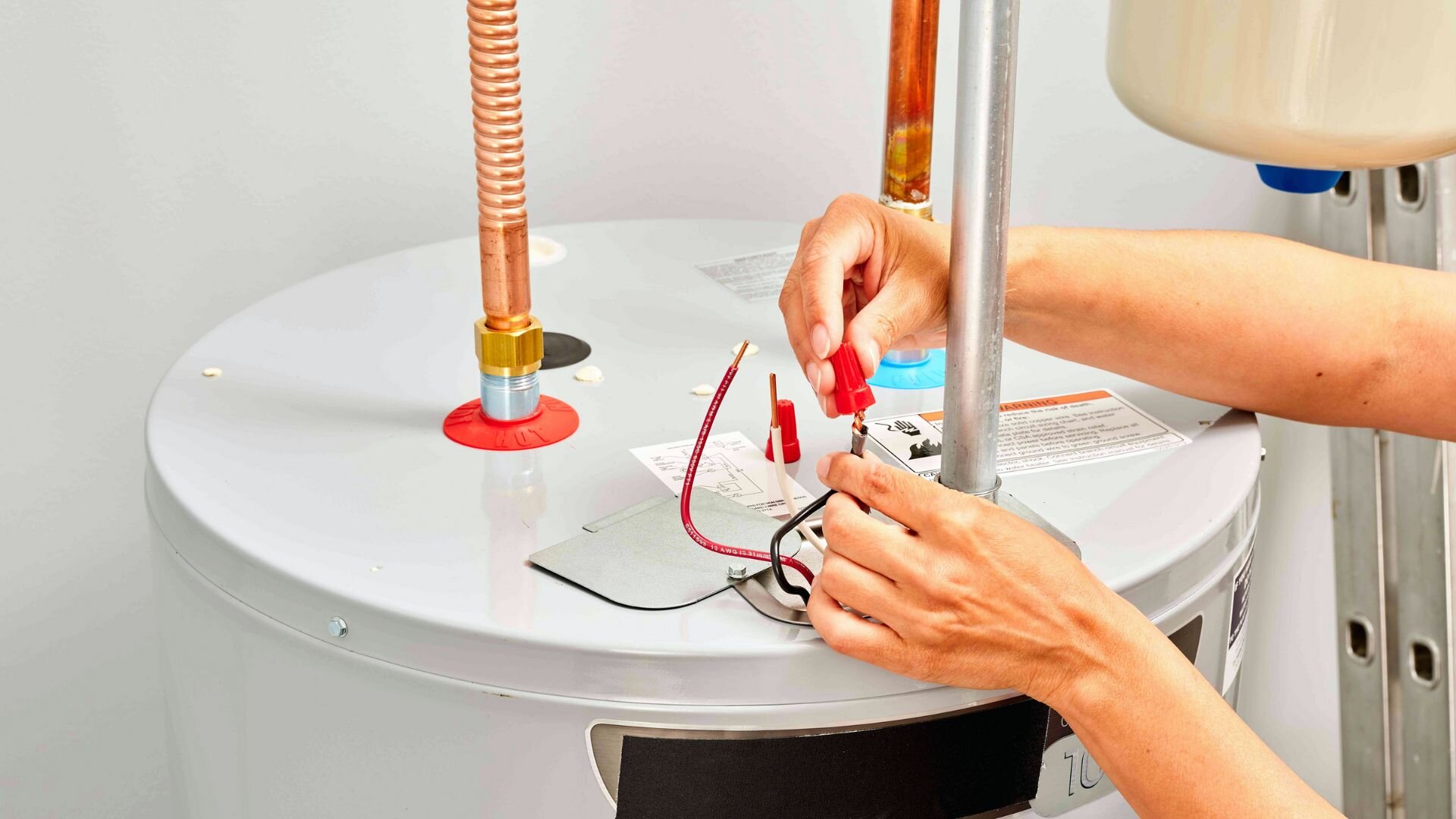 2023 10 Man Fixing The Hot Water System Electricals Man Fixing Hot Water System Electricals
