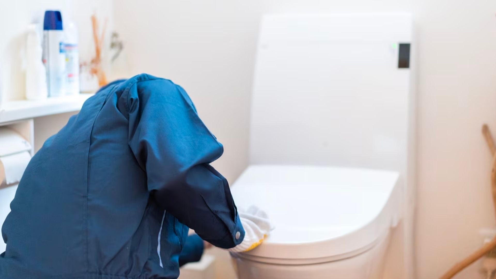 Person Bending Fixing Toilet