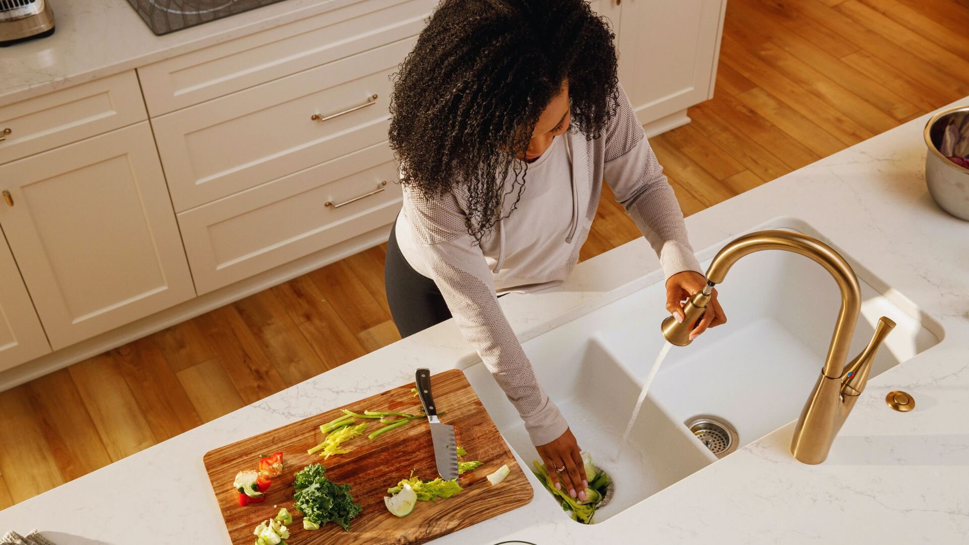 Lady Putting Scraps Garbage Disposal