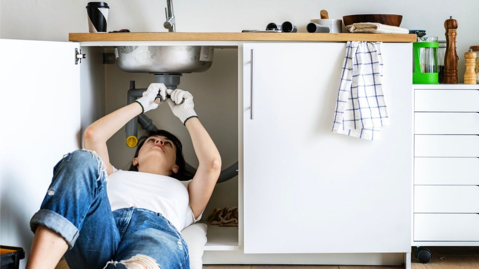 Woman Fixing Sink White Doors