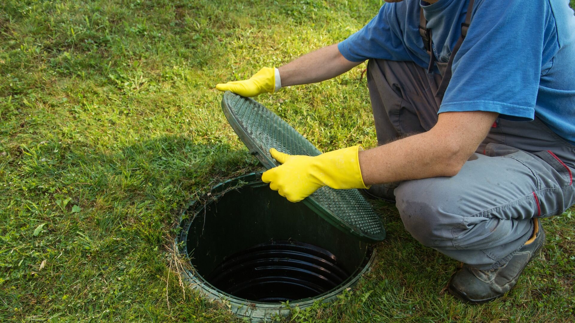 Man Maintaining Sewage Tank