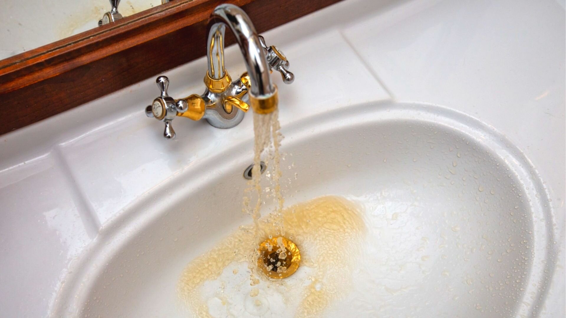 water coming out of vent in bathroom sink