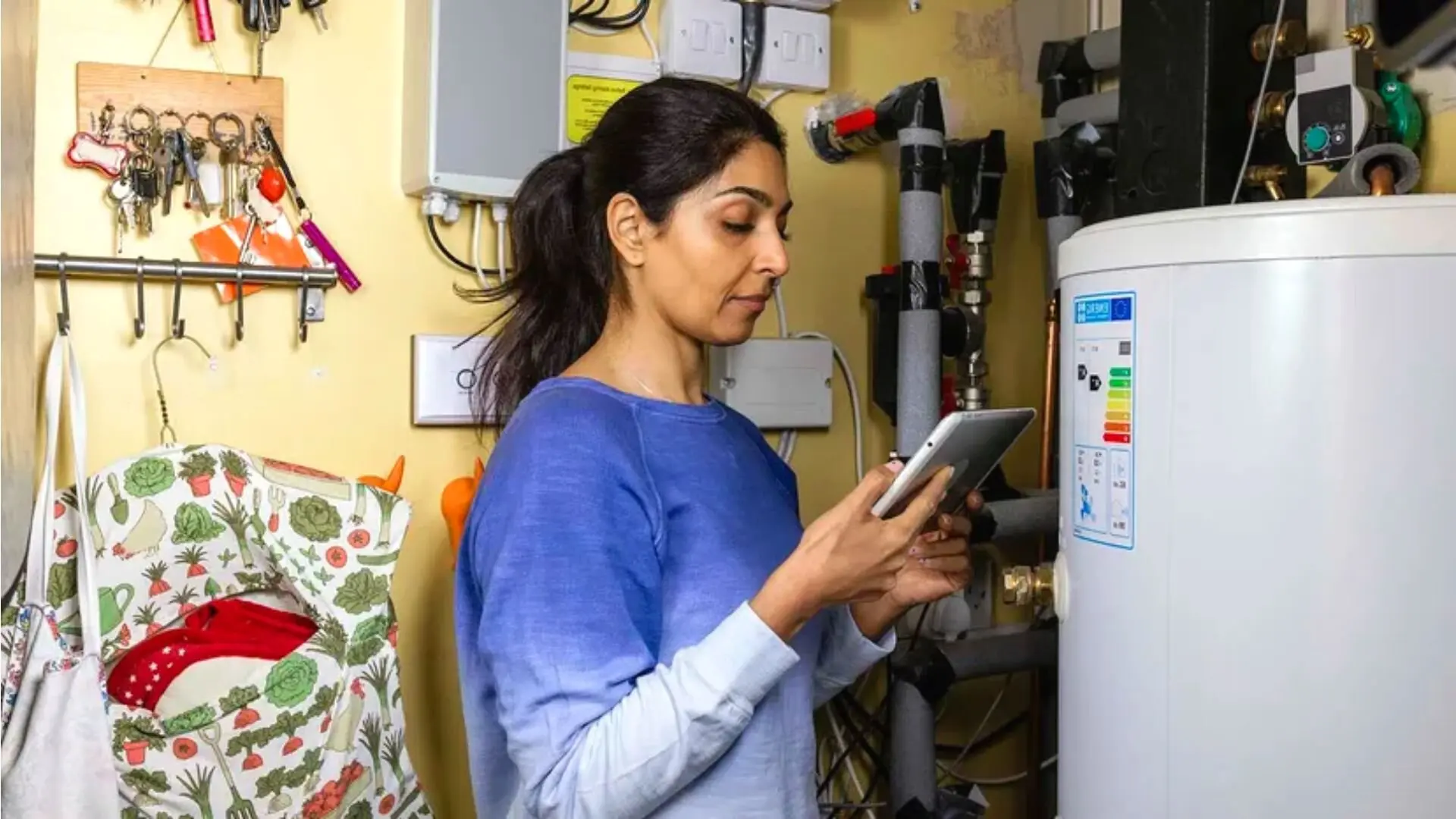 Person Testing Water Heater In Garage Person Testing Water Heater Garage