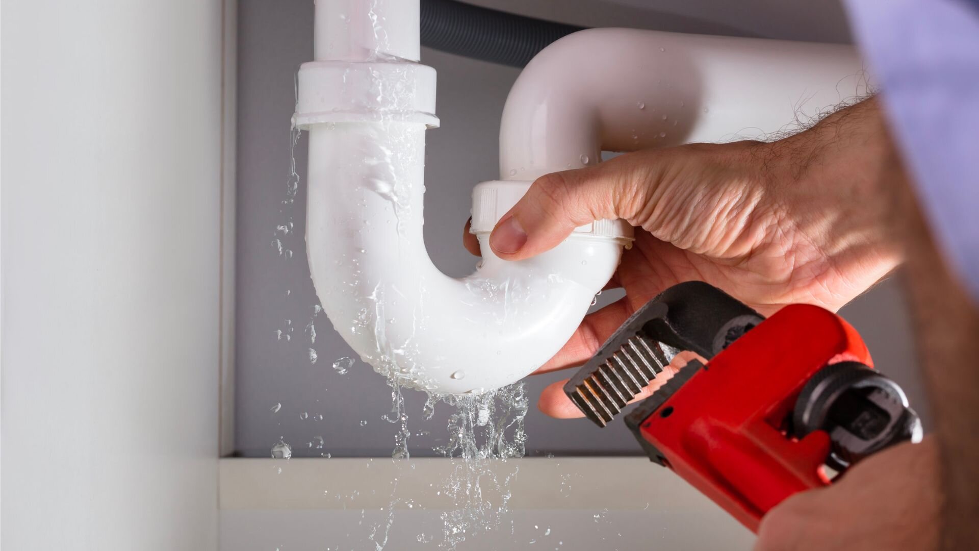 Guy Fixing Pipes Red Wrench