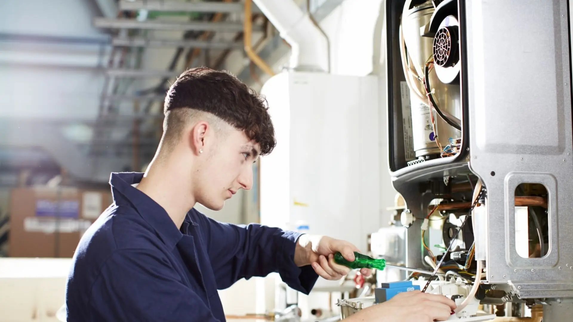 Apprentice Plumber Working On Water Heater Apprentice Plumber Working Water Heater