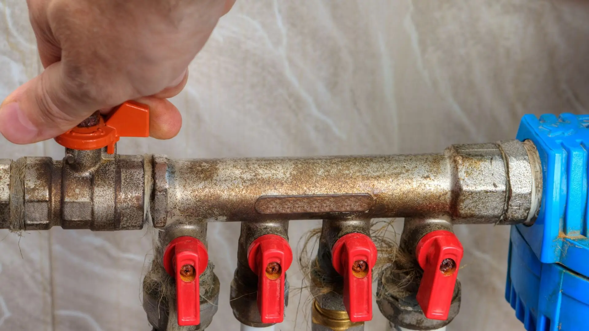 A building manager turning off the main water valve during a plumbing emergency.